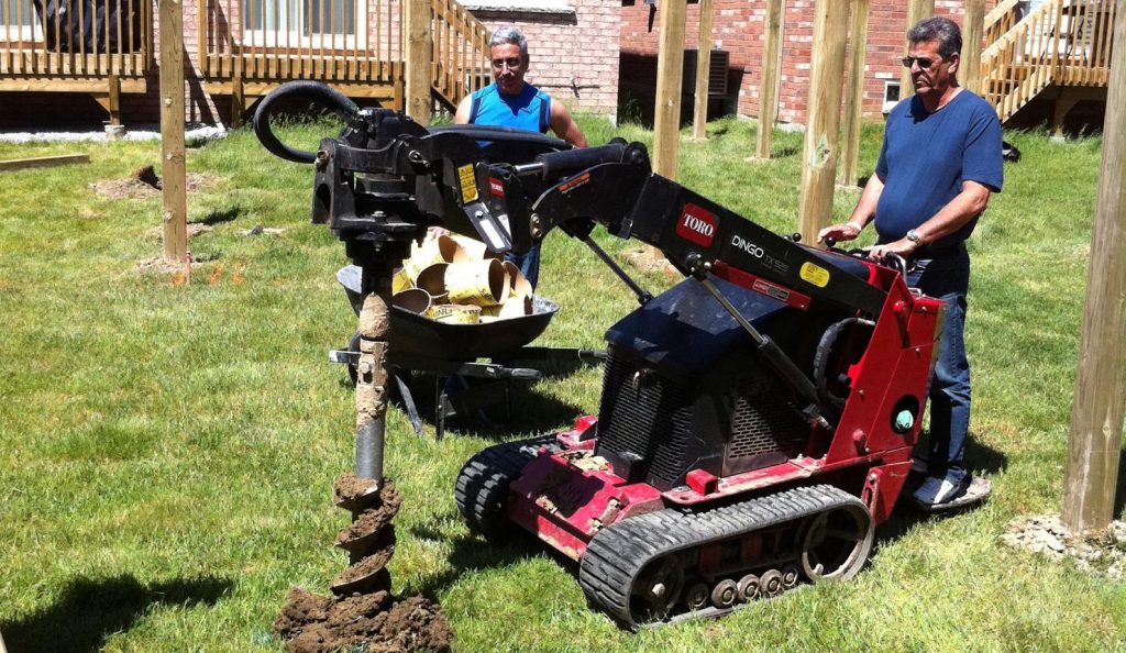 Backyard post hole digging project with earth auger in Abilene TX