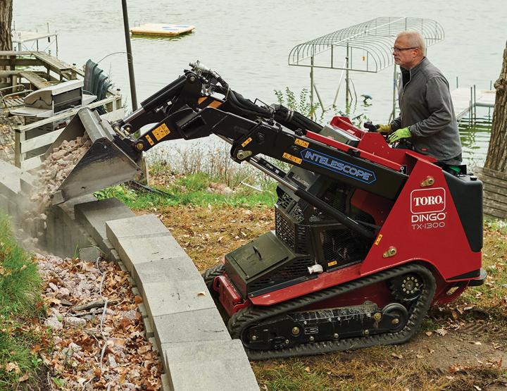 Compact Toro Dingo skid steer leveling backyard in Abilene Texas