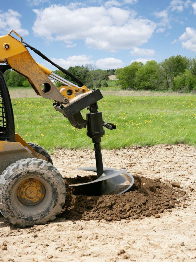Barn construction footing holes drilled with skid steer auger in Abilene TX