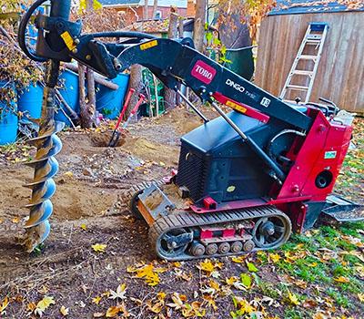 Toro Dingo mini skid steer helping with fence installation in Abilene TX