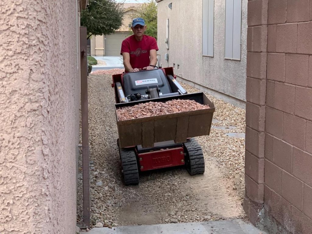 Toro Dingo mini skid steer repairing gravel driveway in Abilene Texas