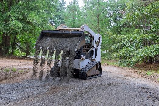 Toro Dingo skid steer spreading gravel on driveway in Abilene TX