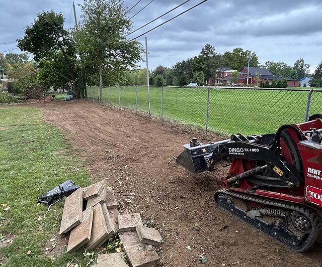 Toro Dingo mini skid steer clearing brush in Abilene Texas