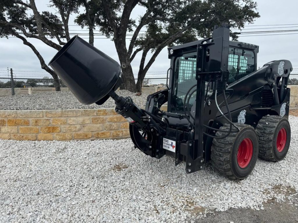 Toro Dingo mini skid steer with auger attachment digging fence post holes in Abilene TX