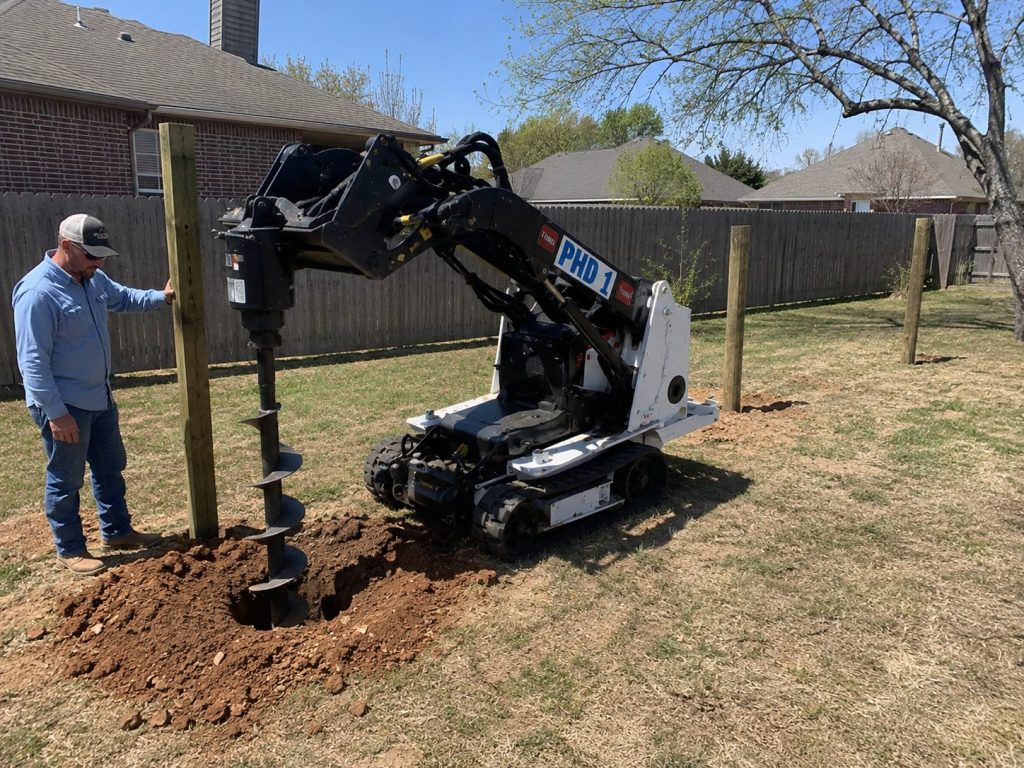 Toro Dingo post hole digging along residential fence line in Abilene TX