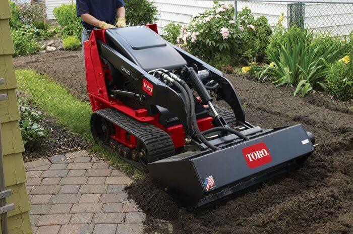 Toro Dingo mini skid steer grading dirt in Abilene TX