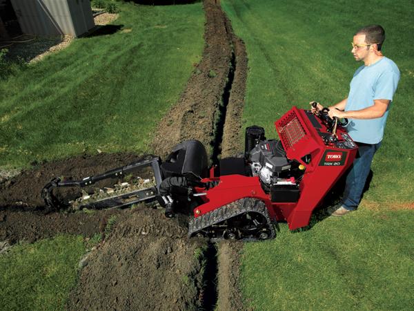 Toro mini skid steer with trencher attachment digging trench in Abilene TX