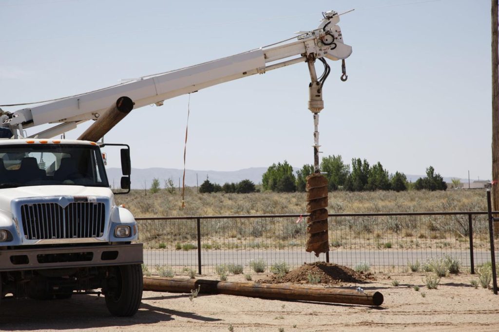 Utility pole drilling with skid steer auger in Abilene TX
